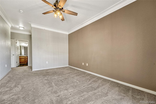 spare room featuring carpet flooring, ceiling fan, and crown molding