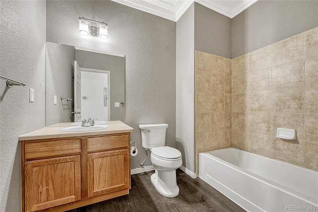 full bathroom featuring ornamental molding, vanity, shower / bathing tub combination, hardwood / wood-style floors, and toilet