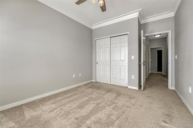 unfurnished bedroom with ceiling fan, a closet, light colored carpet, and ornamental molding