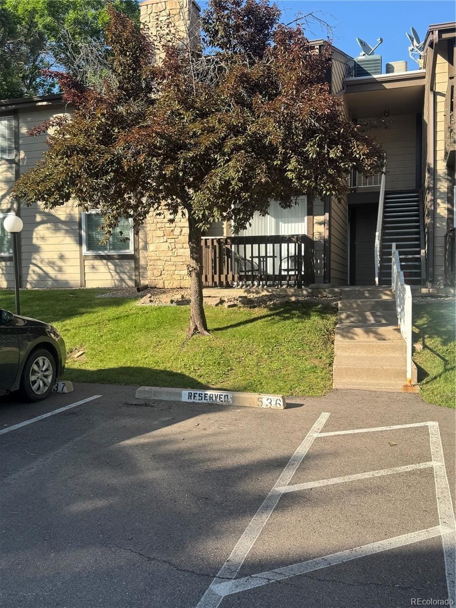 1850 S Pitkin Cir Unit B, Aurora, CO 80017 - view of front of home with uncovered parking and a front lawn