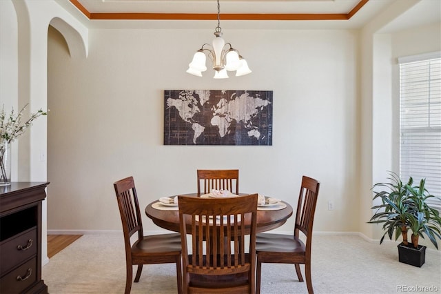 carpeted dining area with baseboards and a notable chandelier