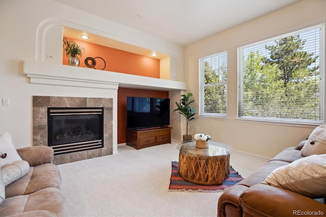 living room featuring baseboards, a fireplace, and carpet flooring