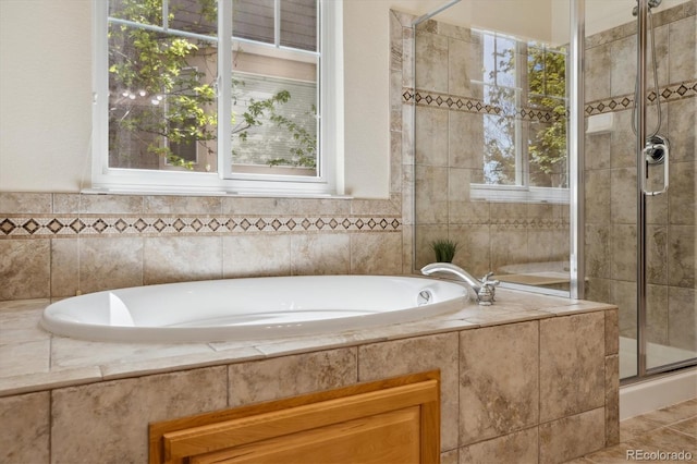 full bathroom featuring a bath and a stall shower