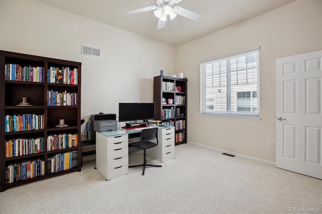 home office with ceiling fan, visible vents, light carpet, and baseboards