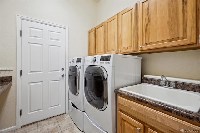clothes washing area featuring independent washer and dryer, light tile patterned floors, a sink, and cabinet space