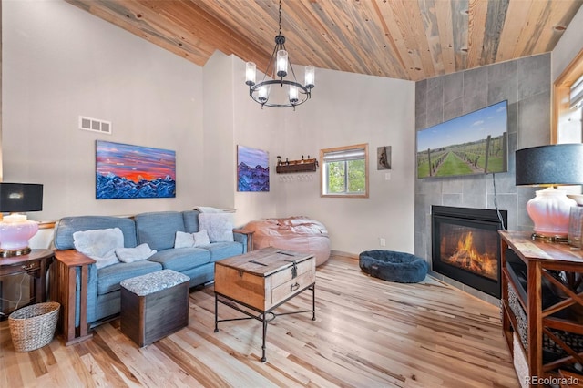 332 Harris St, Bailey, CO 80421 - living area with vaulted ceiling, wood ceiling, wood finished floors, a fireplace, and a chandelier