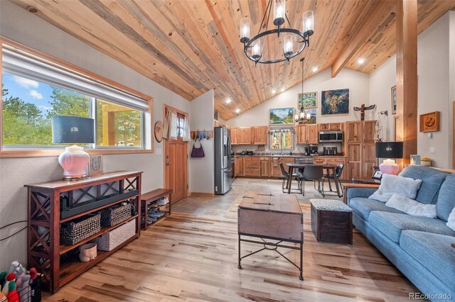 332 Harris St, Bailey, CO 80421 - living area with a chandelier, light wood-style floors, high vaulted ceiling, and wooden ceiling with exposed beams