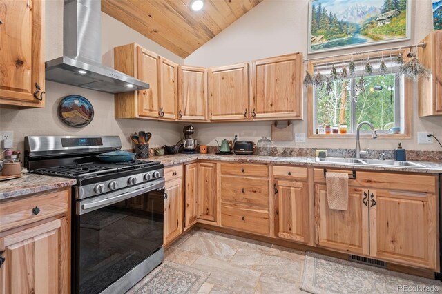 332 Harris St, Bailey, CO 80421 - kitchen with stainless steel gas range, wall chimney range hood, a sink, lofted ceiling, and light stone finish flooring