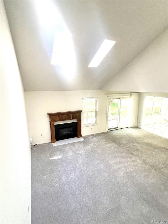 unfurnished living room with carpet floors and lofted ceiling