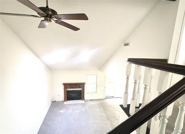 unfurnished living room featuring carpet, ceiling fan, and lofted ceiling