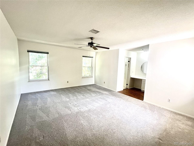 interior space featuring a textured ceiling, plenty of natural light, and ceiling fan