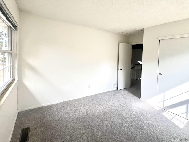 unfurnished bedroom with carpet floors and a closet