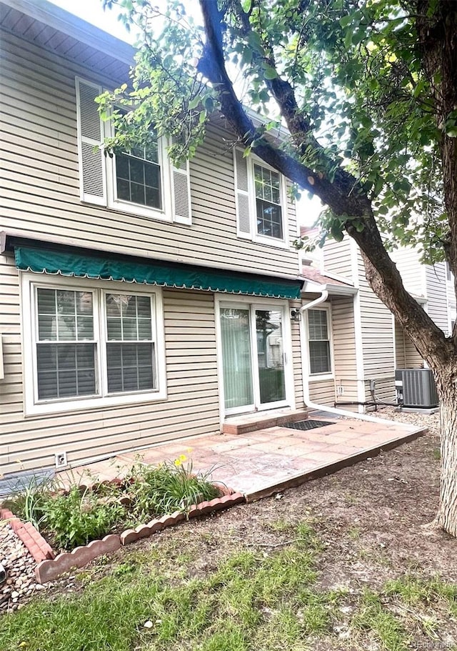 rear view of house with a patio area and central AC