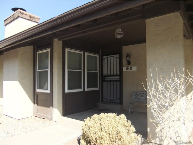 entrance to property with stucco siding