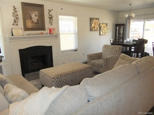 living area with a notable chandelier and a fireplace