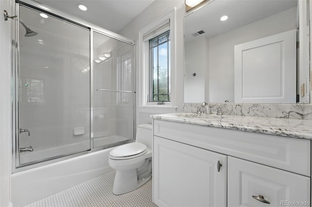 1351 S Milwaukee St, Denver, CO 80210 - full bathroom with vanity, toilet, enclosed tub / shower combo, recessed lighting, and tile patterned floors