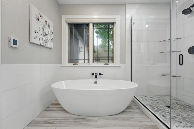 1351 S Milwaukee St, Denver, CO 80210 - full bathroom with tile walls, a shower stall, and a freestanding bath