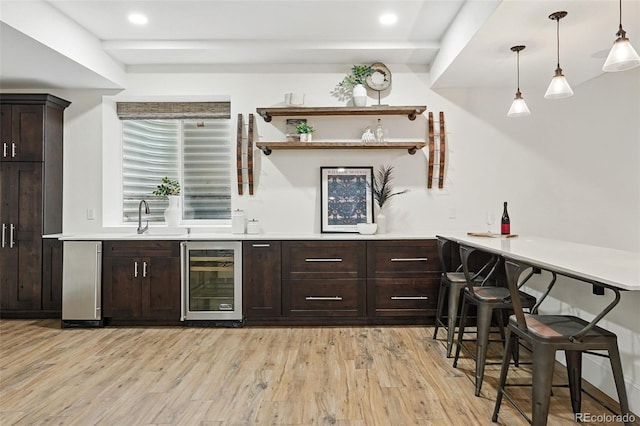 1351 S Milwaukee St, Denver, CO 80210 - indoor wet bar with wine cooler, light wood-style flooring, recessed lighting, and pendant lighting