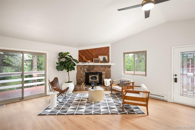 19424 Silver Ranch Rd, Conifer, CO 80433 - living room with baseboard heating, light wood-style floors, a ceiling fan, and vaulted ceiling