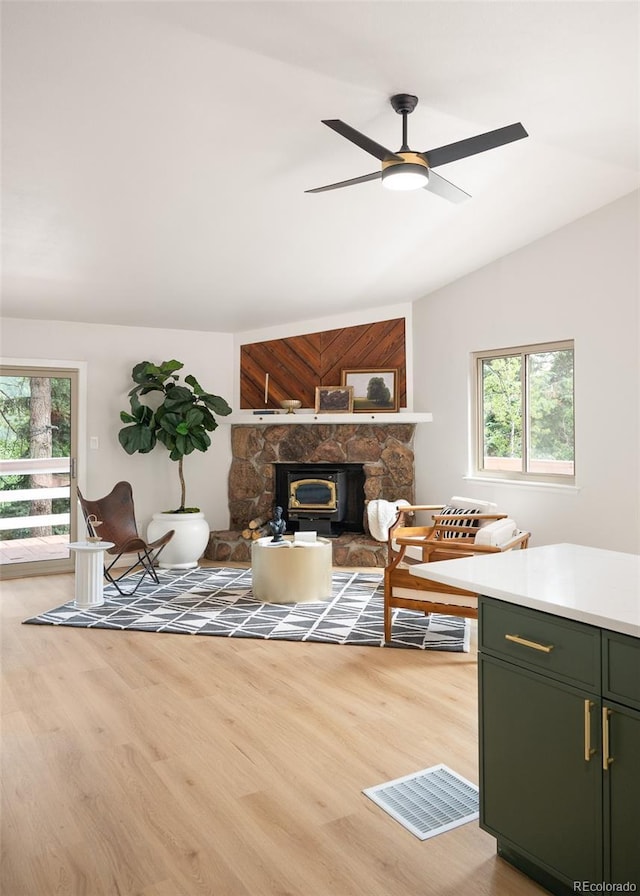 19424 Silver Ranch Rd, Conifer, CO 80433 - living area featuring plenty of natural light, light wood finished floors, a ceiling fan, a fireplace, and vaulted ceiling