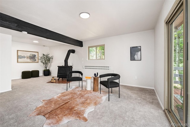 19424 Silver Ranch Rd, Conifer, CO 80433 - living area with a wood stove, carpet flooring, and beamed ceiling