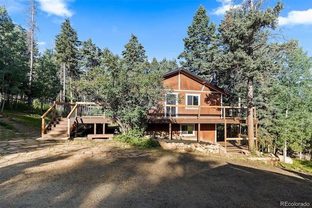 19424 Silver Ranch Rd, Conifer, CO 80433 - back of property featuring a wooden deck and stairs