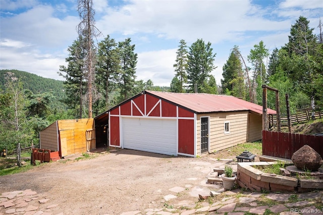 19424 Silver Ranch Rd, Conifer, CO 80433 - detached garage featuring a view of trees