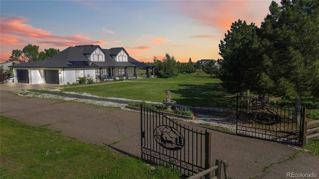 1550 Ajax St, Strasburg, CO 80136 - view of front of home with asphalt driveway, a garage, and a porch