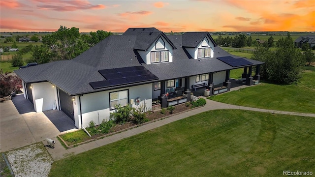 1550 Ajax St, Strasburg, CO 80136 - view of front of house with an outdoor hangout area, a shingled roof, solar panels, driveway, and stucco siding