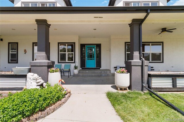 1550 Ajax St, Strasburg, CO 80136 - property entrance featuring stucco siding, covered porch, and ceiling fan