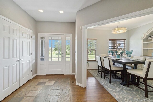 1550 Ajax St, Strasburg, CO 80136 - foyer featuring recessed lighting, wood finished floors, and crown molding