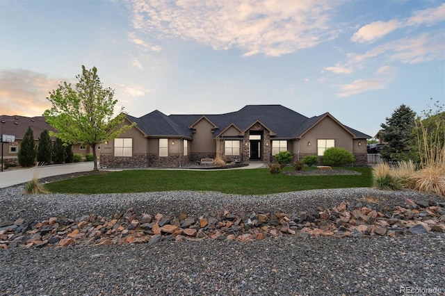 12939 Wabash Ct, Thornton, CO 80602 - view of front of home with stone siding, a front lawn, and stucco siding