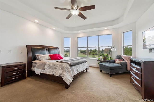 12939 Wabash Ct, Thornton, CO 80602 - bedroom featuring multiple windows, light colored carpet, recessed lighting, a ceiling fan, and a raised ceiling