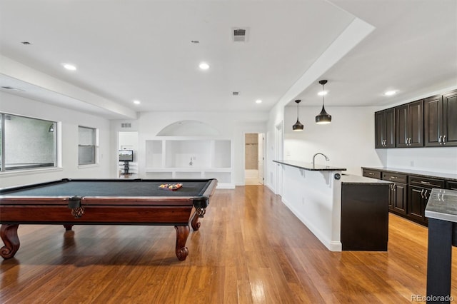 12939 Wabash Ct, Thornton, CO 80602 - recreation room featuring light wood finished floors, recessed lighting, built in shelves, pool table, and baseboards