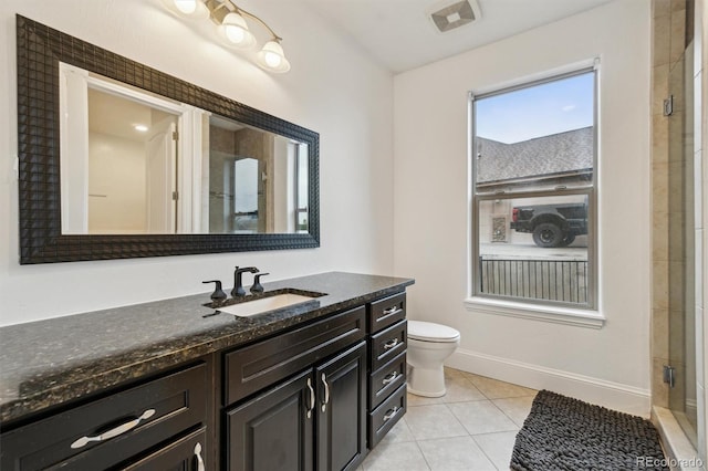 12939 Wabash Ct, Thornton, CO 80602 - bathroom with vanity, tile patterned floors, toilet, an enclosed shower, and baseboards
