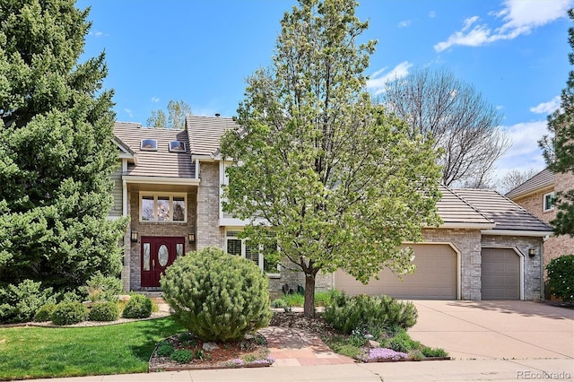 5320 S Geneva St, Englewood, CO 80111 - view of front of house with a tile roof, concrete driveway, brick siding, and a garage