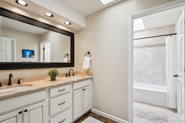 5320 S Geneva St, Englewood, CO 80111 - bathroom with a skylight, double vanity, recessed lighting, baseboards, and shower / bath combo