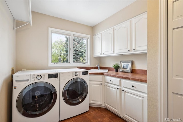5320 S Geneva St, Englewood, CO 80111 - laundry room featuring cabinet space, washing machine and clothes dryer, and dark tile patterned floors