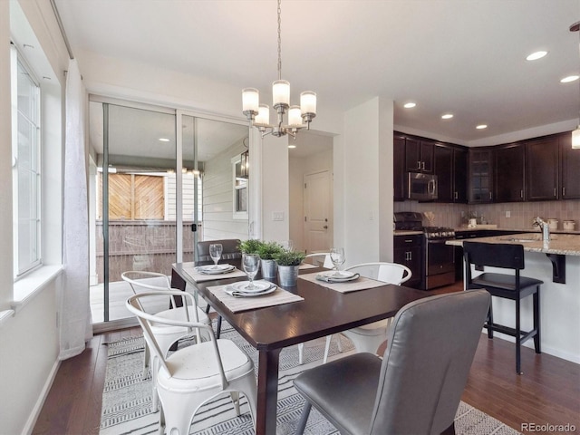 15350 W 50th Dr, Golden, CO 80403 - dining space with a chandelier, recessed lighting, dark wood finished floors, and baseboards