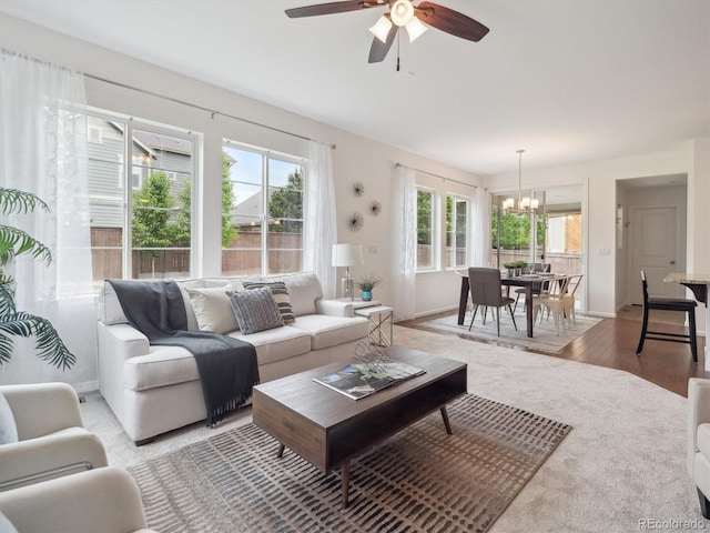 15350 W 50th Dr, Golden, CO 80403 - living area featuring a chandelier, ceiling fan, light wood-style flooring, and baseboards