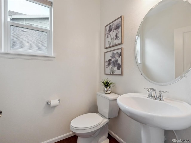 15350 W 50th Dr, Golden, CO 80403 - half bathroom featuring toilet, baseboards, and a sink