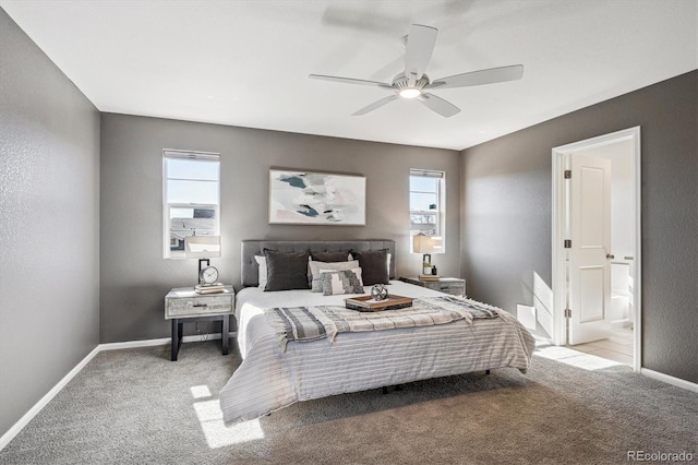 carpeted bedroom with a ceiling fan, multiple windows, and baseboards