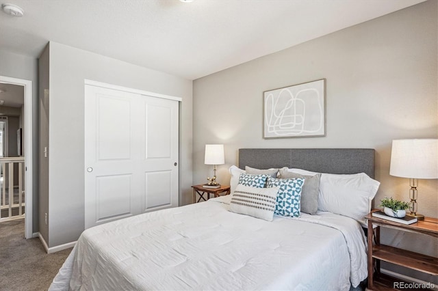 bedroom featuring a closet, carpet flooring, and baseboards