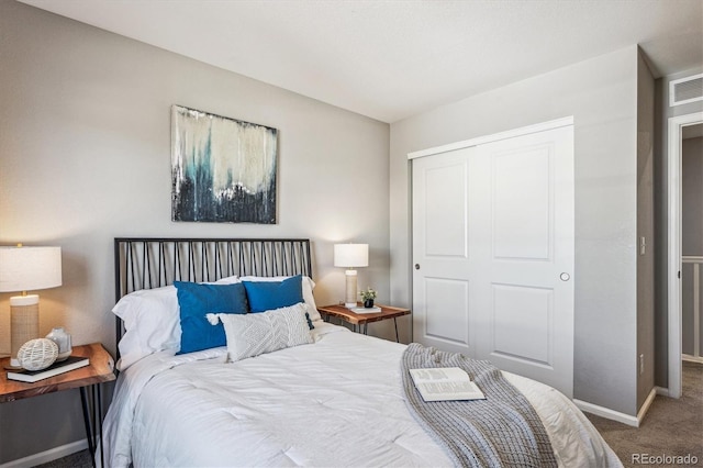 bedroom with carpet floors, a closet, and baseboards