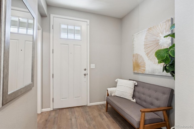 entryway with wood finished floors and baseboards