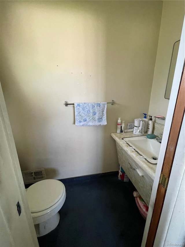 bathroom featuring a sink, toilet, and baseboards