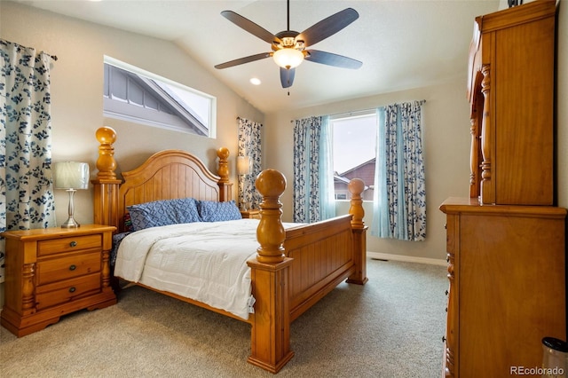 bedroom with multiple windows, ceiling fan, light colored carpet, and lofted ceiling