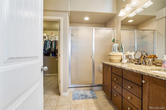 bathroom featuring tile patterned floors, vanity, and an enclosed shower