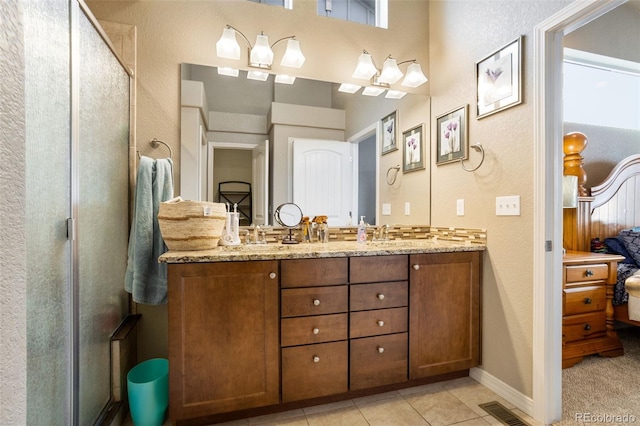 bathroom featuring tile patterned flooring and vanity