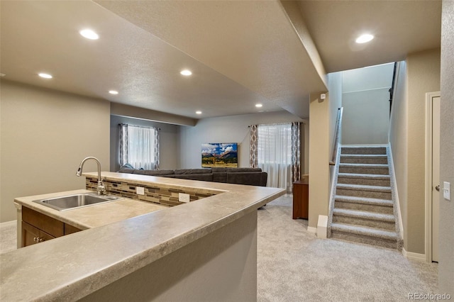 kitchen featuring sink and light colored carpet